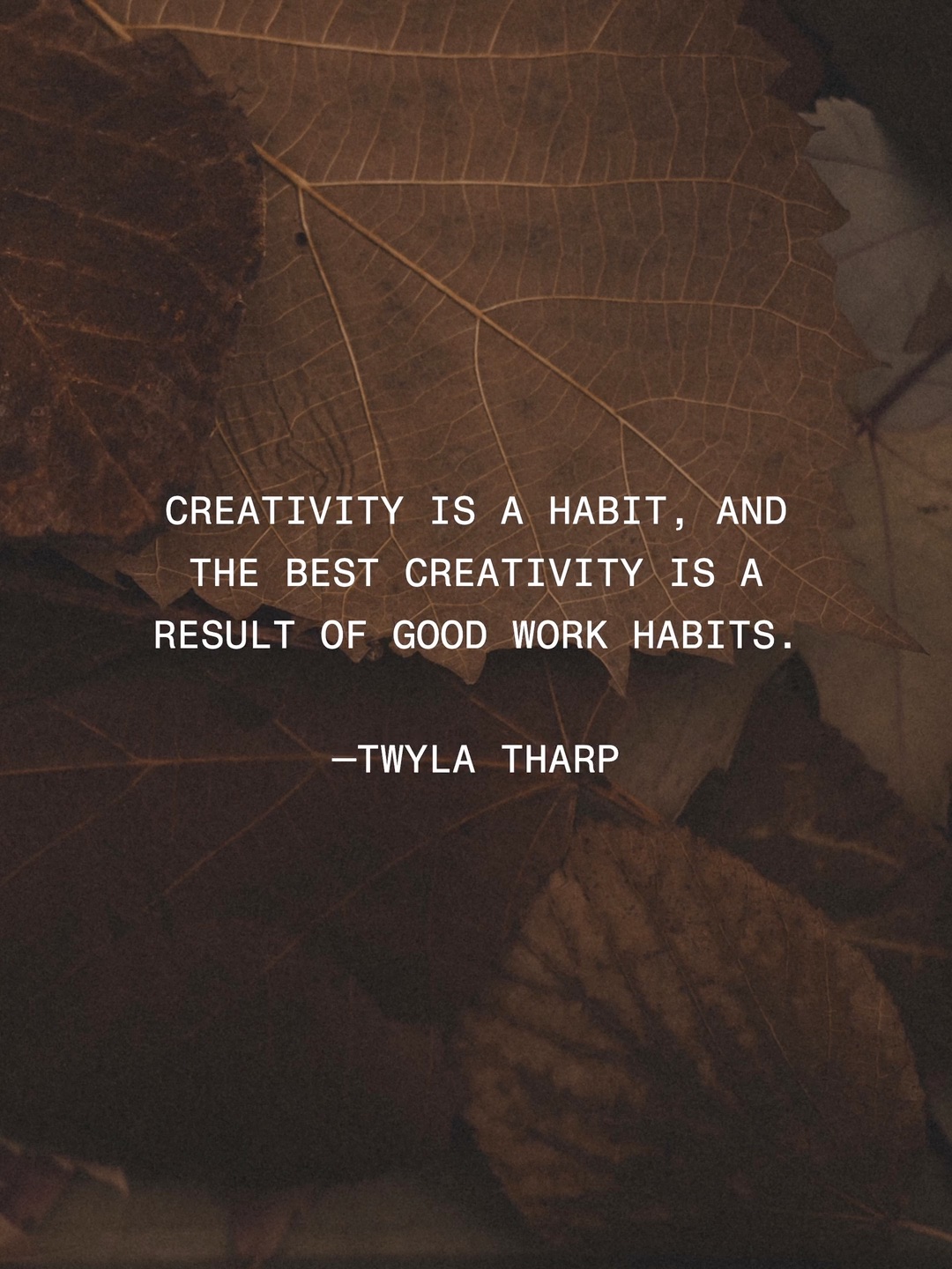 A quote by Twyla Tharp in small white capitals over dark autumn leaves.